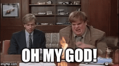 A Man In A Suit And Tie Is Sitting At A Table With A Toy Car On It And Says Oh My God . GIF