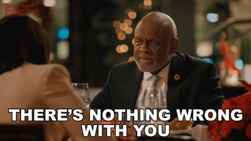 A Man In A Suit And Tie Is Sitting At A Table With A Woman And Says There 'S Nothing Wrong With You GIF