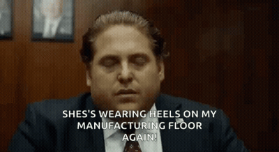 A Man In A Suit And Tie Is Sitting At A Table With His Eyes Closed And Talking . GIF
