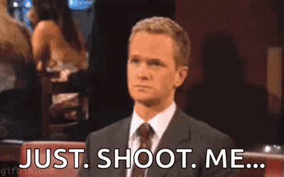 A Man In A Suit And Tie Is Sitting At A Table With His Hand On His Face . GIF