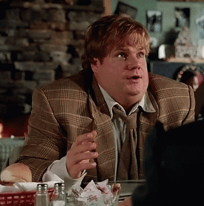 A Man In A Suit And Tie Is Sitting At A Table With Salt And Pepper Shakers GIF