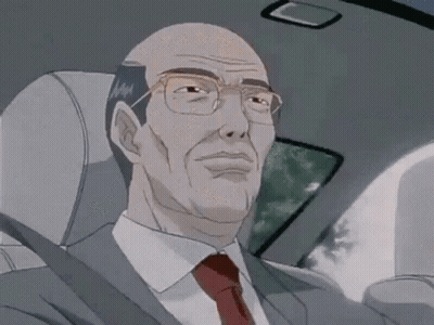 A Man In A Suit And Tie Is Sitting In A Car . GIF