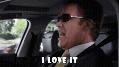 A Man In A Suit And Tie Is Sitting In A Car And Says I Love It GIF