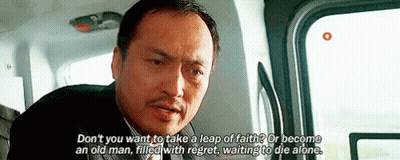 A Man In A Suit And Tie Is Sitting In A Car And Talking To Someone . GIF