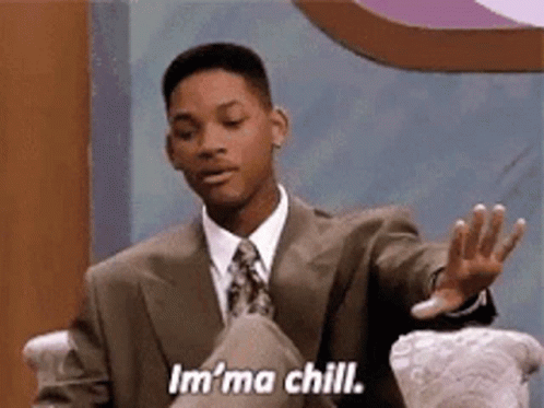 A Man In A Suit And Tie Is Sitting In A Chair And Saying `` I 'M A Chill . '' GIF