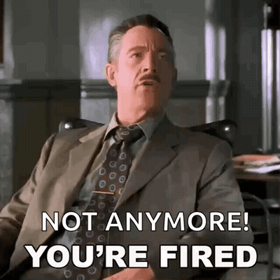 A Man In A Suit And Tie Is Sitting In A Chair And Saying `` Not Anymore ! You 'Re Fired '' . GIF