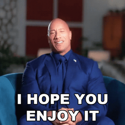 A Man In A Suit And Tie Is Sitting In A Chair And Says " I Hope You Enjoy It " GIF