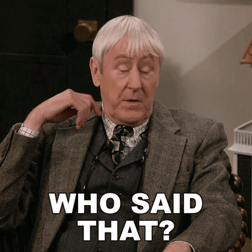 A Man In A Suit And Tie Is Sitting In A Chair And Says " Who Said That " GIF