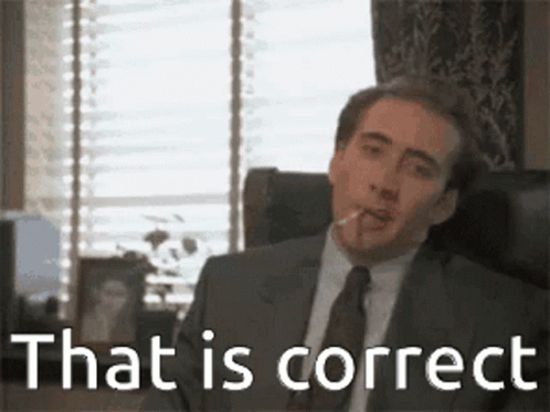 A Man In A Suit And Tie Is Sitting In A Chair Smoking A Cigarette And Saying `` That Is Correct '' . GIF