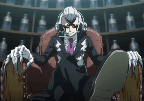 A Man In A Suit And Tie Is Sitting In A Chair With His Feet Crossed GIF