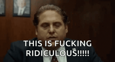 A Man In A Suit And Tie Is Sitting In A Room With His Eyes Closed And Saying This Is Fucking Ridiculous . GIF