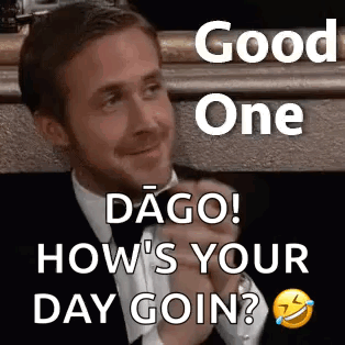 A Man In A Suit And Tie Is Sitting In Front Of A Fireplace And Smiling . GIF