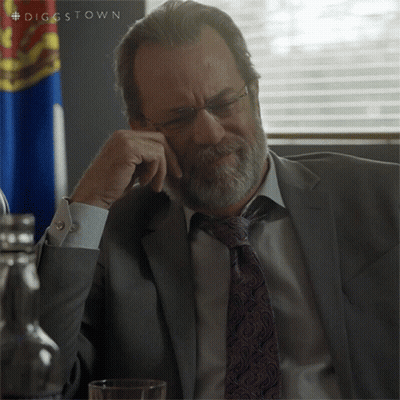 a man in a suit and tie is sitting in front of a flag with the hashtag diggstown