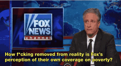 A Man In A Suit And Tie Is Sitting In Front Of A Fox News Channel Sign GIF