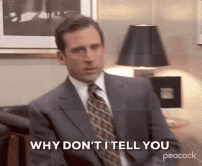A Man In A Suit And Tie Is Sitting In Front Of A Lamp And Says Why Do N't I Tell You . GIF