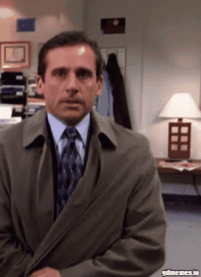 A Man In A Suit And Tie Is Sitting In Front Of A Lamp With Gifmemes.io Written On The Bottom GIF
