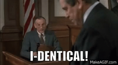 A Man In A Suit And Tie Is Sitting In Front Of A Microphone In A Courtroom . GIF
