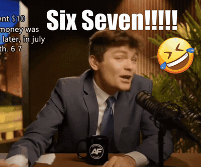 A Man In A Suit And Tie Is Sitting In Front Of A Microphone With The Words Six Seven Written On It GIF