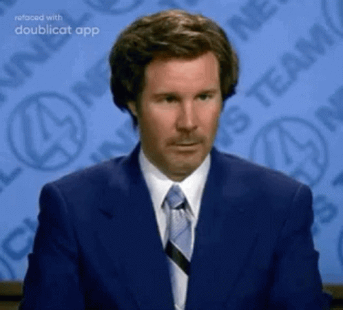A Man In A Suit And Tie Is Sitting In Front Of A Newspaper . GIF