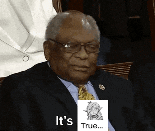 A Man In A Suit And Tie Is Sitting In Front Of A Picture That Says " It 'S True " GIF