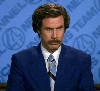 A Man In A Suit And Tie Is Sitting In Front Of A Wall That Has Channel 4 News Team Written On It GIF