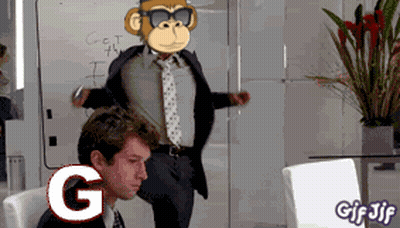 A Man In A Suit And Tie Is Sitting In Front Of A White Board With A Monkey On It GIF