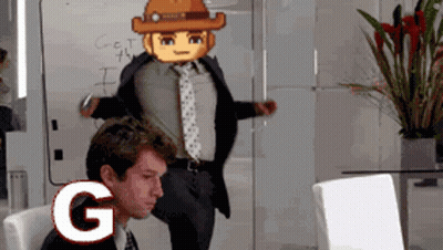 A Man In A Suit And Tie Is Sitting In Front Of A White Board With The Letter G Written On It GIF