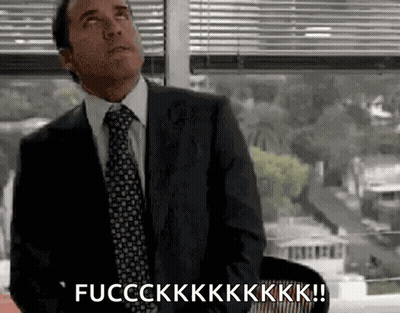 A Man In A Suit And Tie Is Sitting In Front Of A Window And Saying Fucckkk ! GIF