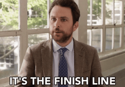 A Man In A Suit And Tie Is Sitting In Front Of A Window And Saying It 'S The Finish Line . GIF