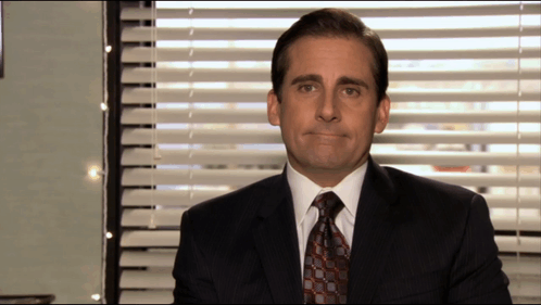 Man In Suit Sitting In Front Of Window GIF