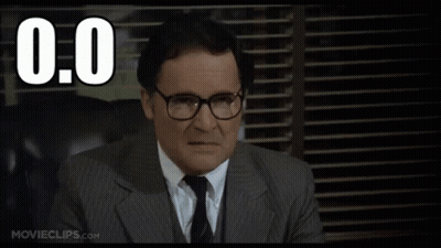 A Man In A Suit And Tie Is Sitting In Front Of A Window With The Number 0.0 Written Above Him GIF