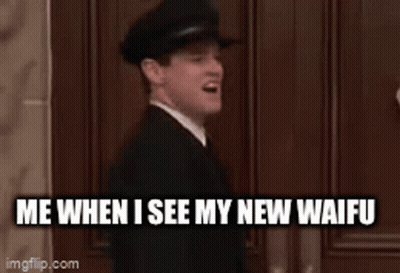 A Man In A Suit And Tie Is Sitting In Front Of A Wooden Door . GIF