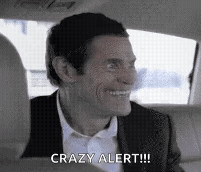 A Man In A Suit And Tie Is Sitting In The Back Seat Of A Car . GIF