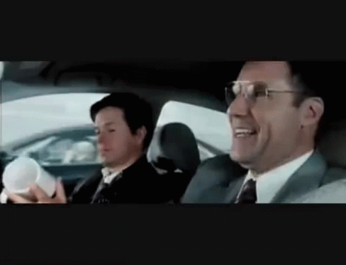 A Man In A Suit And Tie Is Sitting In The Back Seat Of A Car GIF