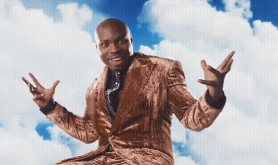 A Man In A Suit And Tie Is Sitting In The Clouds With His Arms Outstretched GIF