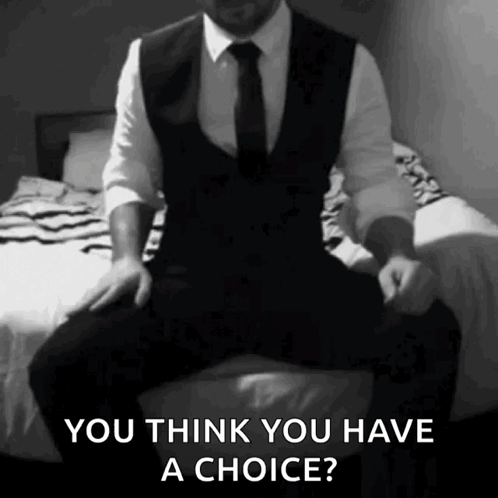 A Man In A Suit And Tie Is Sitting On A Bed And Says You Think You Have A Choice ? GIF