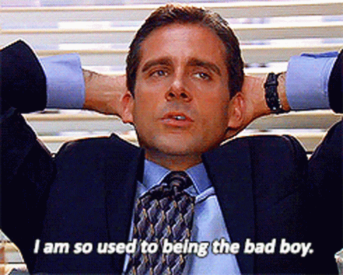 Man In Suit Sitting With Hands Behind Head Saying I Am So Used To Being The Bad Boy GIF