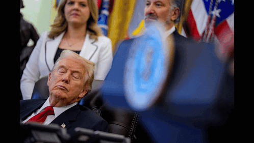 A Man In A Suit And Tie Is Sleeping In A Chair With His Eyes Closed GIF