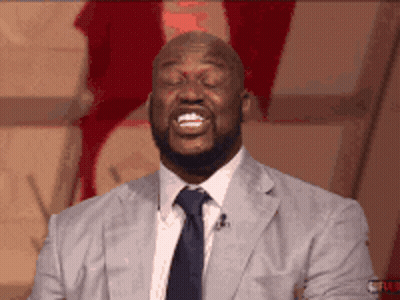 A Man In A Suit And Tie Is Smiling GIF
