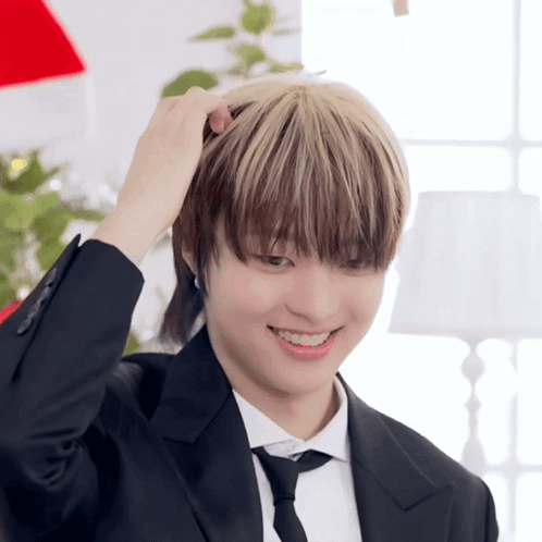 A Man In A Suit And Tie Is Smiling GIF