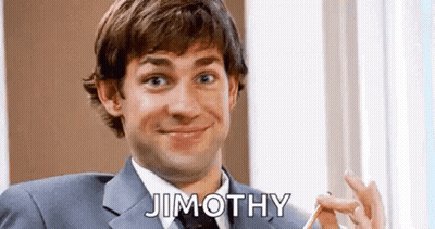 A Man In A Suit And Tie Is Smiling And Holding A Pencil In His Hand . GIF