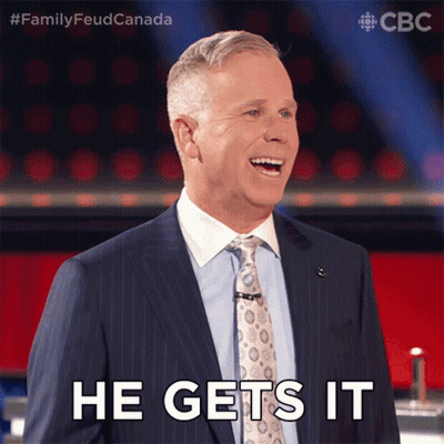 A Man In A Suit And Tie Is Smiling And Saying He Gets It GIF
