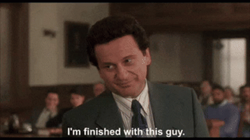 A Man In A Suit And Tie Is Smiling And Saying I 'M Finished With This Guy GIF