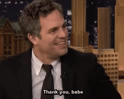A Man In A Suit And Tie Is Smiling And Saying Thank You Babe GIF