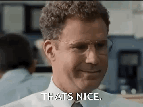 A Man In A Suit And Tie Is Smiling And Saying `` That 'S Nice . '' GIF