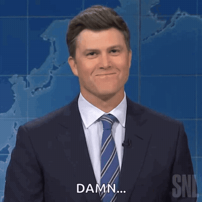 A Man In A Suit And Tie Is Smiling And Says Damn GIF