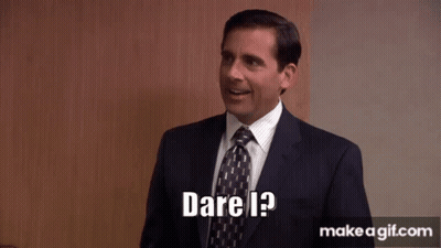 A Man In A Suit And Tie Is Smiling And Says Dare I ? GIF
