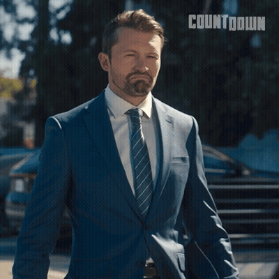 A Man In A Suit And Tie Is Smiling And Says I Think You Have The Wrong Man GIF