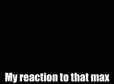 A Man In A Suit And Tie Is Smiling And Says My Reaction To That Max GIF