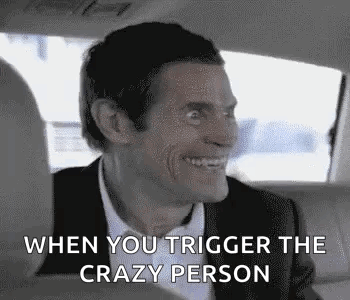 A Man In A Suit And Tie Is Smiling In A Car . GIF